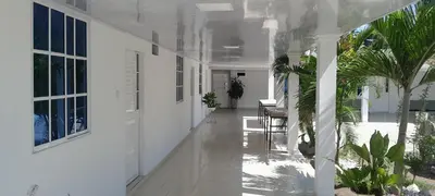 an empty hallway of a white house with plants at Hotel Roy in Santa Marta