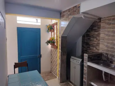 a kitchen with a blue door and a sink at Casa Angie in Cartagena de Indias