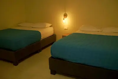 two beds in a room with two beds sidx sidx sidx at Alma Del Mar in Cartagena de Indias