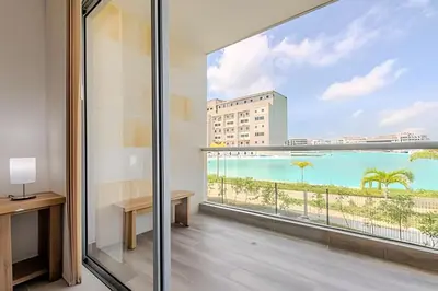 a room with a view of the beach from a balcony at Vista a Laguna cristalina + 2 alc + parking in Cartagena de Indias