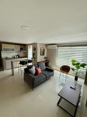 a living room with a couch and a table at Apto Moderno Cómodo y acogedor Excelente ubicación Norte Barranquilla in Barranquilla