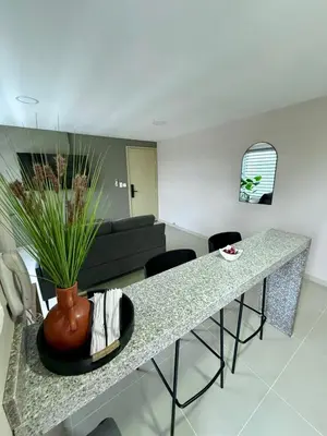 a living room with a table and a couch at Apto Moderno Cómodo y acogedor Excelente ubicación Norte Barranquilla in Barranquilla