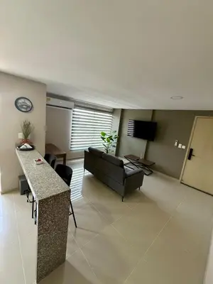 a living room with a couch and a table at Apto Moderno Cómodo y acogedor Excelente ubicación Norte Barranquilla in Barranquilla
