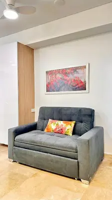 a gray couch in a room with a painting at Sunset Loft frente al mar CB1506 in Cartagena de Indias