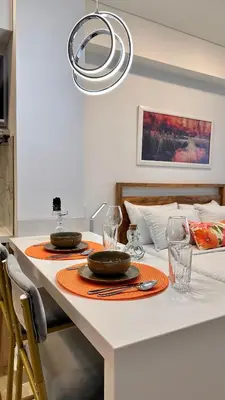 a dining table with two plates and glasses on it at Sunset Loft frente al mar CB1506 in Cartagena de Indias