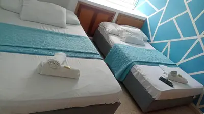 two beds in a hotel room with towels on them at apto cartagena con vista al mar 11 in Cartagena de Indias