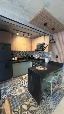 a kitchen with a table and a stove top oven at Barranquilla Dreams in Puerto Colombia