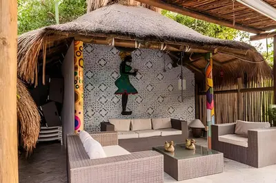 a pavilion with a couch and chairs and a table at Tita Tati Disconnect near Cartagena in Punta Canoas