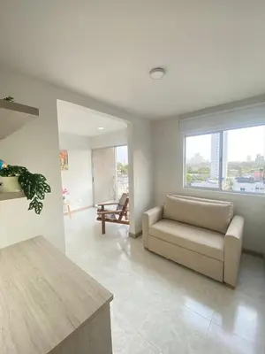 a living room with a couch and a large window at Cartagena Chic Full Apto in Cartagena de Indias