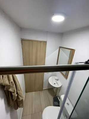 a bathroom with a sink and a toilet and a mirror at Sky View Apartment en Barranquilla in Barranquilla