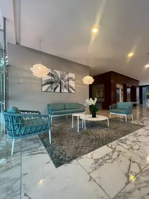a lobby with blue couches and a table at Morros Vitri directo al Mar in Cartagena de Indias