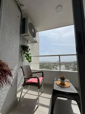 a balcony with a chair and a table at Villas del mar in Cartagena de Indias
