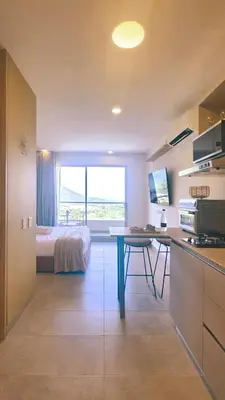 a bedroom with a bed and a desk in a room at Caribbean Refuge - Beach and Pool Access 10th Floor in Santa Marta