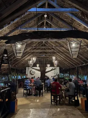 a group of people sitting at tables in a restaurant at Ekoparque Lunaforest in Guayepo