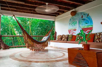 a room with a hammock and a large window at Ekoparque Lunaforest in Guayepo