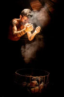 a man with tattoos jumping over a grill with smoke at Ekoparque Lunaforest in Guayepo