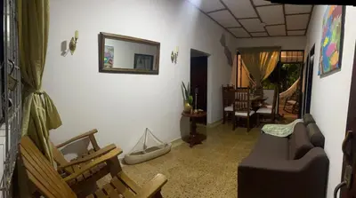 a living room with chairs and a couch and a mirror at Habitación con baño privado y aíre acondicionado frente al mar in Santiago