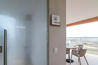 a dining room with a table and chairs and a window at Modern Apartment Cielo Mar Terrace-Pool-Jacuzzi Close to the beach in Cartagena de Indias