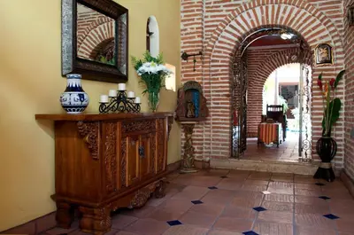 a hallway with an archway and a mirror on a wall at Luxury Colonial Villa Old City Cartagena Rooftop Views Private Pool in Cartagena de Indias