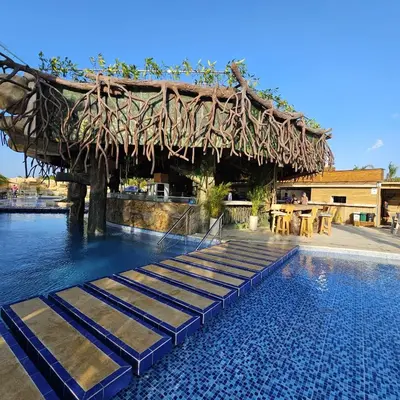 a resort with a swimming pool with a pavilion at Aves de Laguna Beach
