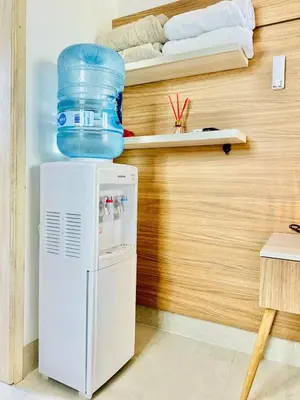 a refrigerator with a water container on top of it at Aves de Laguna Beach in Trementino