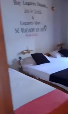 two beds in a room with writing on the wall at Confort Compartida Ctg x3 in Cartagena de Indias