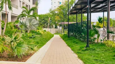 a walkway in a park next to a building at 1BD Luxe Shore & Balcony Sunrise Next to the Beach in Santa Marta