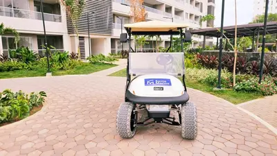 a golf cart parked in front of a building at 1BD Luxe Shore & Balcony Sunrise Next to the Beach in Santa Marta