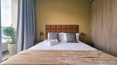 a bedroom with a large bed and a window at Seaside Retreat Beach Entrance 20th Floor in Santa Marta