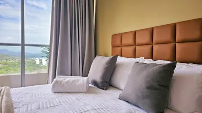 a bedroom with a large bed with a large window at Seaside Retreat Beach Entrance 20th Floor in Santa Marta
