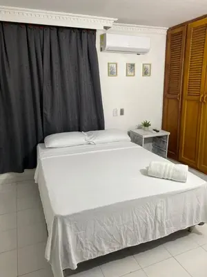 a bedroom with two beds and a window at Habitación cerca al aeropuerto # 5 in Cartagena de Indias