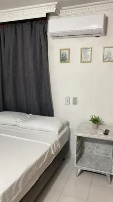 a bedroom with a bed and a table at Habitación cerca al aeropuerto # 5 in Cartagena de Indias