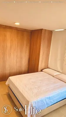a bed in a room with wood paneling at Barranquilla Super Suite Elite in Barranquilla