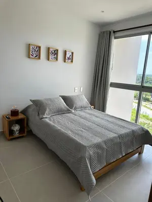a bed in a bedroom with a large window at Baia Kristal Andrés Cartagena in Cartagena de Indias