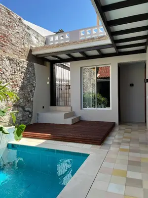 a house with a swimming pool and a patio at Casa Pozo del Carretero in Cartagena de Indias
