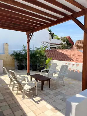 a group of chairs and a table on a patio at Casa Pozo del Carretero in Cartagena de Indias