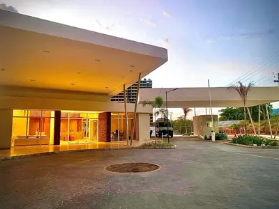 a large building with a parking lot in front of it at Anny Luxury Apartment - Santa Marina in Santa Marta