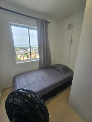 a bedroom with a bed and a large window at Apartamento Moderno 2H cerca Aeropuerto, Playas y Centro Historico in Cartagena de Indias