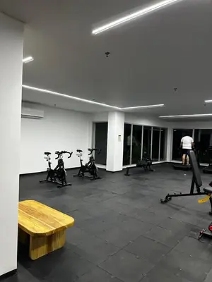 a gym with exercise bikes and a wooden table at Baia Kristal Andrés Cartagena in Cartagena de Indias