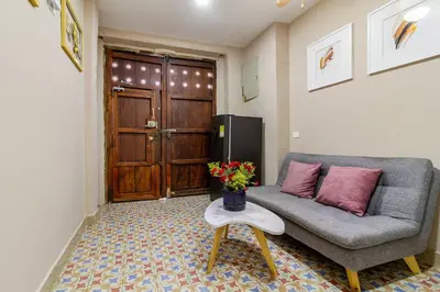 a living room with a couch and a table with flowers at Casa Cristi #5 in Cartagena de Indias