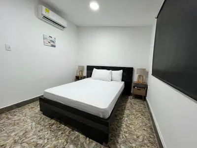 a bedroom with a bed and a tv in it at Family house colonial-style in Cartagena de Indias