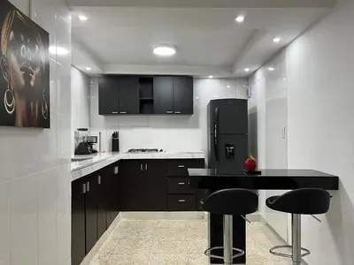 a kitchen with a black counter and black appliances at Family house colonial-style in Cartagena de Indias