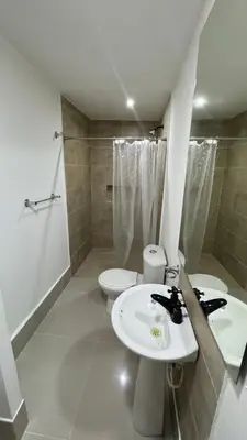 a bathroom with two sinks and a toilet and a shower at Lindo Apartamento en la Boquilla BBB 4 pax in Cartagena de Indias