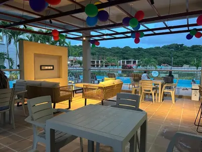 a patio with tables and chairs and a pool at Cartagena 2 Hab con Terraza Privada Playa 12 min Parking in Manzanillo del Mar