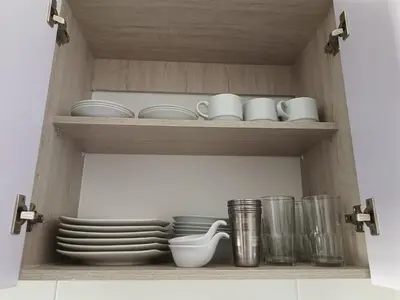 a wooden shelf with plates and cups and dishes at Lindo apartamento a 5 minutos del mar!!! in Manzanillo del Mar