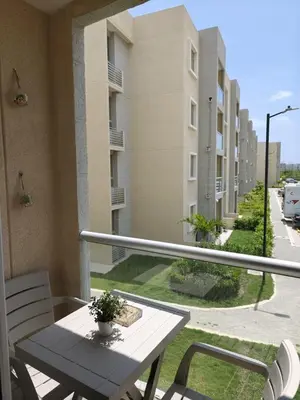a balcony with a table and chairs and a street at Lindo apartamento a 5 minutos del mar!!! in Manzanillo del Mar