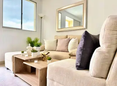 a living room with a couch and a table at Lindo apartamento a 5 minutos del mar!!! in Manzanillo del Mar