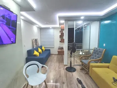a living room with a blue couch and chairs at Exclusive Full Apartment in Cartagena in Cartagena de Indias