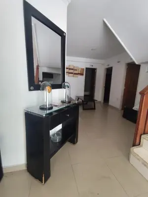 a black dresser with a mirror in a room at Hotel Madeleine Norte in Barranquilla