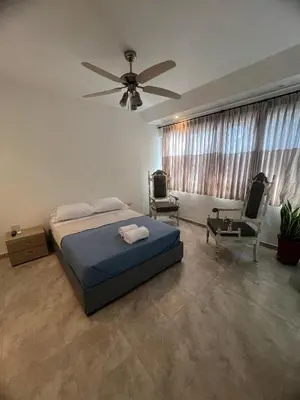 a bedroom with a bed and a ceiling fan at Casa Crespo Caribe Cartagena in Cartagena de Indias